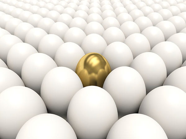 gold egg amidst white eggs